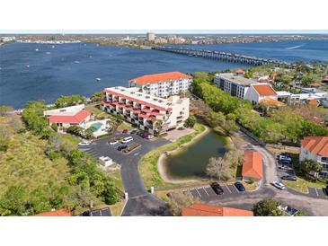 Aerial view of waterfront condo community with pool and parking at 204 3Rd W St # 203, Bradenton, FL 34205