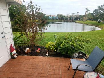 Relaxing patio with pond view, brick pavers, and lush landscaping at 2905 51St W Ave, Bradenton, FL 34205