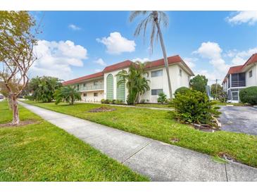 Building exterior showcasing landscaping and parking at 3500 Beneva Rd # 303, Sarasota, FL 34232