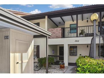 Condo building exterior with parking and landscaping at 365 Three Lakes Ln # G, Venice, FL 34285