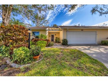 Bright yellow house with attached garage and lush landscaping at 4045 Oakhurst Dr # 3125, Sarasota, FL 34233