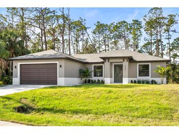 Newly constructed single-Gathering home with a 2-car garage and lush landscaping at 4497 N Salford Blvd, North Port, FL 34286