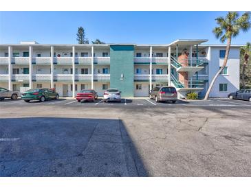 Condo building with parking and tropical landscaping at 5944 Welcome Rd # H25, Bradenton, FL 34207