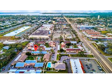 Breathtaking aerial view of a charming coastal community featuring pristine pools and lush landscaping at 6238 7Th W Ave # 6238, Bradenton, FL 34209