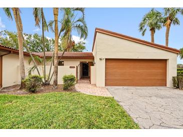Updated condo exterior with a 1 car garage and lush landscaping at 6401 Pelican Dr # 80A, Bradenton, FL 34210