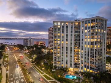 Stunning high-rise building with a swimming pool and views of the water at 1111 N Gulfstream Ave # 4E, Sarasota, FL 34236