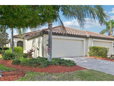 Well-maintained home with a 2-car garage and landscaped yard at 20165 Tesoro Dr, Venice, FL 34293