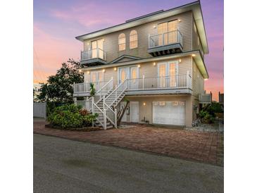 Two-story house with double doors, balconies, and a two-car garage at 3524 Walker Is, Bradenton, FL 34208