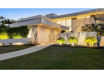 Modern waterfront home with landscaped yard and walkway at 3638 San Remo Ter, Sarasota, FL 34239