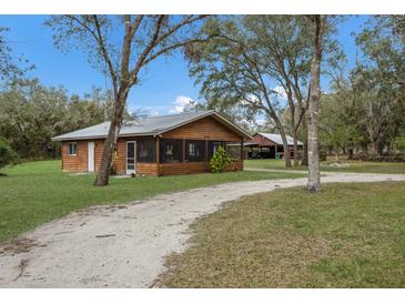 Charming country home with a large yard and screened porch at 38355 State Road 64 E, Myakka City, FL 34251