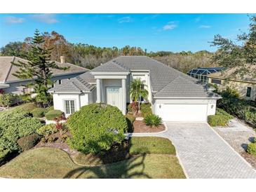 Beautiful one-story home with a tile roof, landscaping, and a two-car garage at 5318 88Th E St, Bradenton, FL 34211