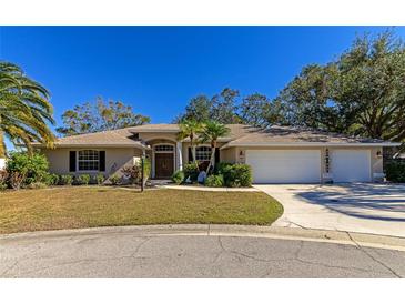 Attractive single-story home with a two-car garage and well-manicured lawn at 5650 Country Walk Ln, Sarasota, FL 34233