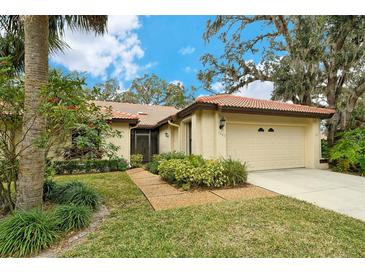 Well-maintained house with a landscaped yard and attached garage at 7363 Silver Fern Blvd # 80, Sarasota, FL 34241