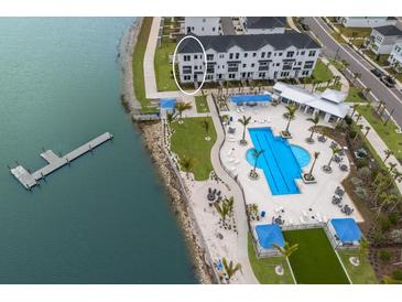 Aerial view of waterfront townhouses with pool and dock at 7420 Newham Ln, Sarasota, FL 34240