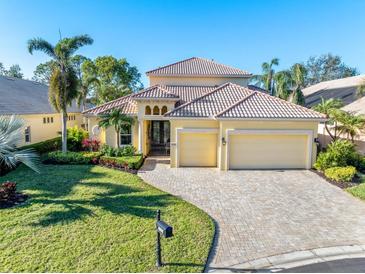 Beautiful two-story home with tile roof, three car garage, and landscaped yard at 8808 Enclave Ct, Sarasota, FL 34238