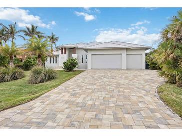 Luxury waterfront home with three-car garage and paver driveway at 103 Graham Se St, Port Charlotte, FL 33952