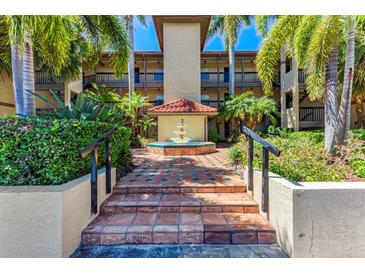 Attractive condo building with courtyard fountain and lush landscaping at 2400 Feather Sound Dr # 215, Clearwater, FL 33762