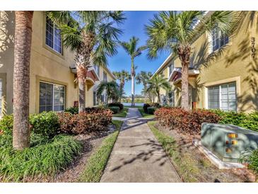 Attractive walkway with landscaping leading to lakefront townhomes at 3715 45Th W Ter # 108, Bradenton, FL 34210