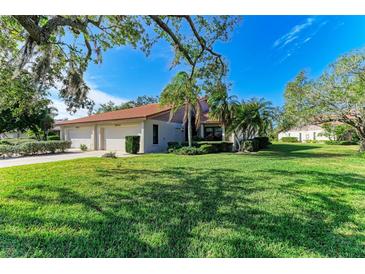 Two-story house with a two-car garage and a lush green lawn at 3803 Wilshire W Cir # 37, Sarasota, FL 34238