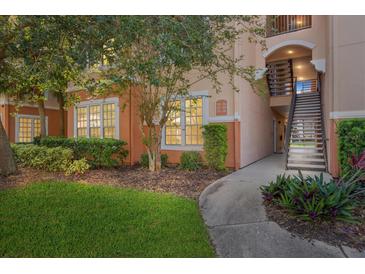 Exterior view of condo building with landscaping and walkway at 4166 Central Sarasota Pkwy # 515, Sarasota, FL 34238