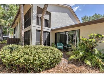 Private patio with lush landscaping and seating area at 4717 Winslow Beacon # 7, Sarasota, FL 34235