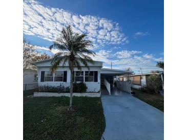 Single-story home with carport and palm tree at 510 50Th Avenue W Dr, Bradenton, FL 34207