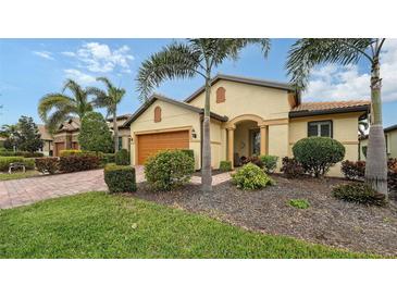 Single-story home with landscaped yard, orange garage door, and palm trees at 5552 Eagle Creek Rd, Sarasota, FL 34238