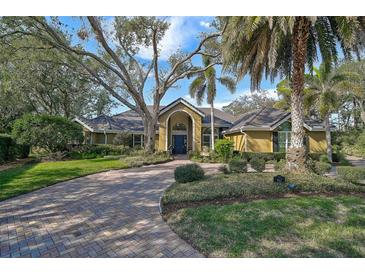 Beautiful 1-story home with a tile roof and lush landscaping at 662 Fernwalk Ln, Osprey, FL 34229