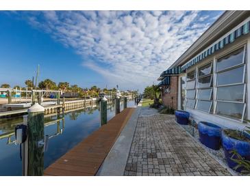 Private dock and canal access with a spacious brick paved patio at 713 Saint Judes S Dr # 2, Longboat Key, FL 34228