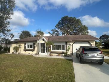 Cute single story home with a nicely landscaped lawn and driveway at 7564 Joppa St, North Port, FL 34287