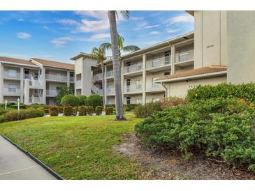 Two-story condo building with lush landscaping and ample parking at 9630 Club South Cir # 6207, Sarasota, FL 34238