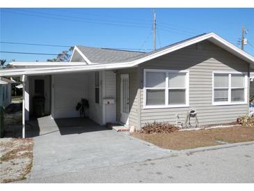 Quaint cottage style home with covered carport and mature landscaping at 12 Desoto E St, Bradenton, FL 34208