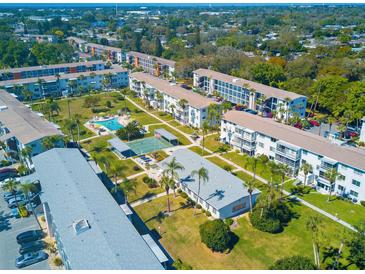 Aerial view of a condo community with pool, and lush landscaping at 1853 Restful Dr # L2, Bradenton, FL 34207