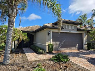 Single-story home with attached garage and landscaped front yard at 19261 Isadora St, Venice, FL 34293