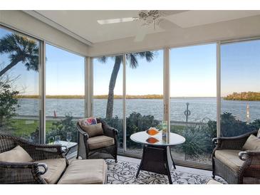 Bright sunroom with water views and comfortable seating at 4310 Falmouth Dr # A104, Longboat Key, FL 34228