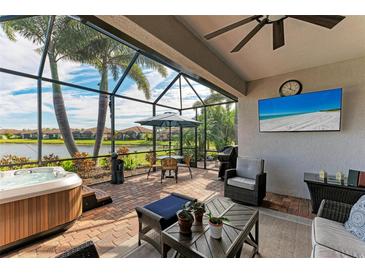 Relaxing screened lanai with hot tub, outdoor seating, and lake view at 6579 Willowshire Way, Bradenton, FL 34212