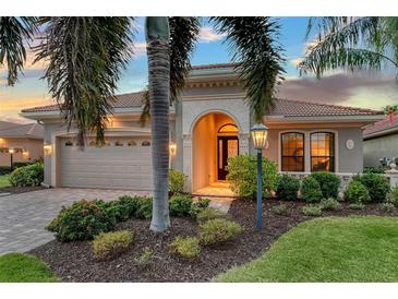 Attractive single-story home with a landscaped yard and a two-car garage at 7312 Riviera Cv, Lakewood Ranch, FL 34202