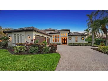 Stunning two-story home with a tile roof, three-car garage, and landscaped yard at 8994 Wildlife Loop, Sarasota, FL 34238