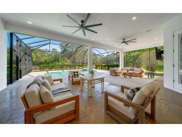 Spacious covered patio with pool and seating area at 14901 17Th E Ave, Bradenton, FL 34212