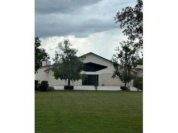 House exterior featuring stone accents and a large window at 15986 Cutting Horse Trl, Myakka City, FL 34251