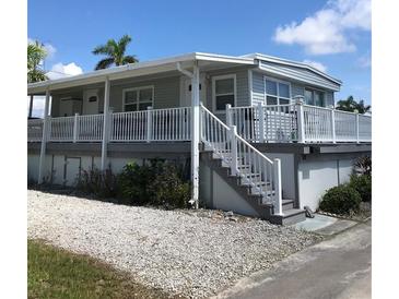 Single-story home with a large deck and white railings at 2601 Gulf N Dr # 528, Bradenton Beach, FL 34217