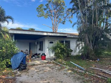 Ranch-style home with carport and mature landscaping at 3241 Williamsburg St, Sarasota, FL 34231