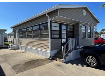 Tan single-wide manufactured home with a carport and small front yard at 3333 26Th E Ave # 1150, Bradenton, FL 34208