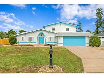 Stunning two-story home with a bright blue garage and nicely landscaped lawn at 5420 4Th Avenue Nw Dr, Bradenton, FL 34209