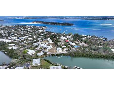 Aerial view of waterfront home with surrounding neighborhood at 625 Jackson Way, Longboat Key, FL 34228