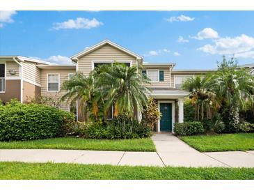 Two-story townhome with a green door and lush landscaping at 7417 Vista Way # 106, Bradenton, FL 34202