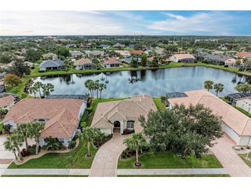 Aerial view of a luxurious house nestled in a waterfront community at 115 Grand Oak Cir, Venice, FL 34292