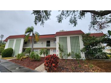 Two-story condo building with red tile roofs and lush landscaping at 3606 Beneva Rd # 502, Sarasota, FL 34232