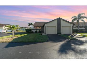 Two-story condo with attached garage, and lush landscaping at 3920 Bal Harbor Blvd # E1, Punta Gorda, FL 33950