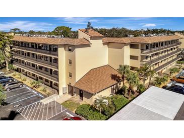 Condo building with multiple units, ample parking, and lush landscaping at 435 30Th W Ave # D309, Bradenton, FL 34205